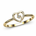 Angled view of golden open-heart ring with a clear solitaire stone