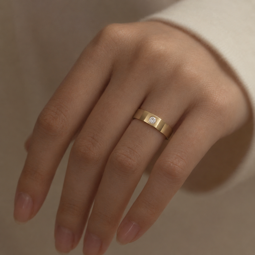 Two-tone bezel solitaire band ring worn on hand in soft neutral light